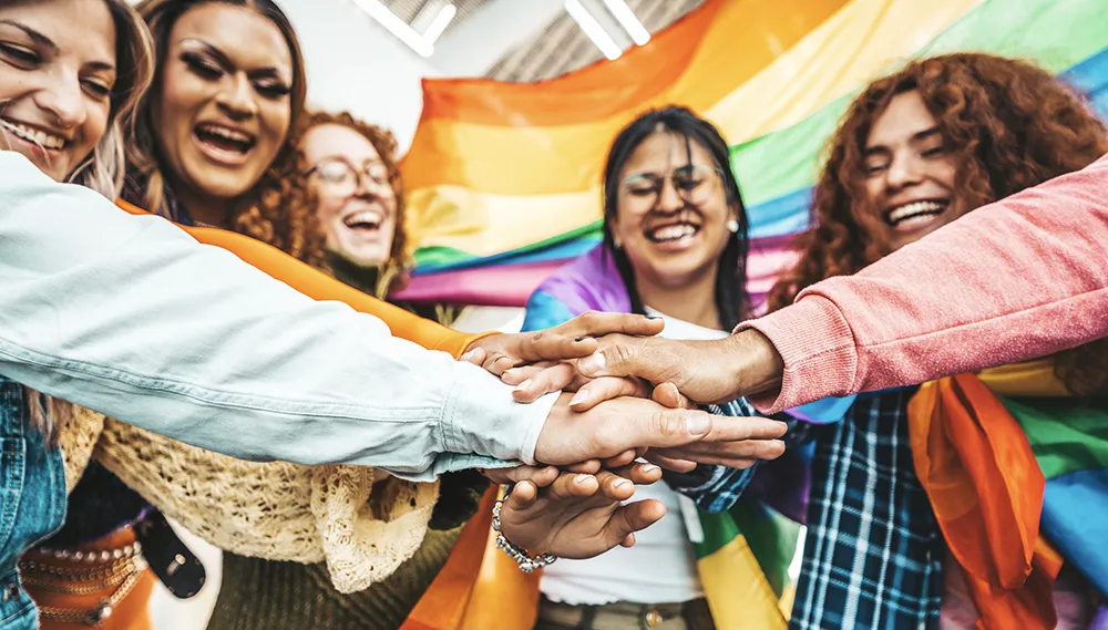 a group of proud Rainbow people holding hands